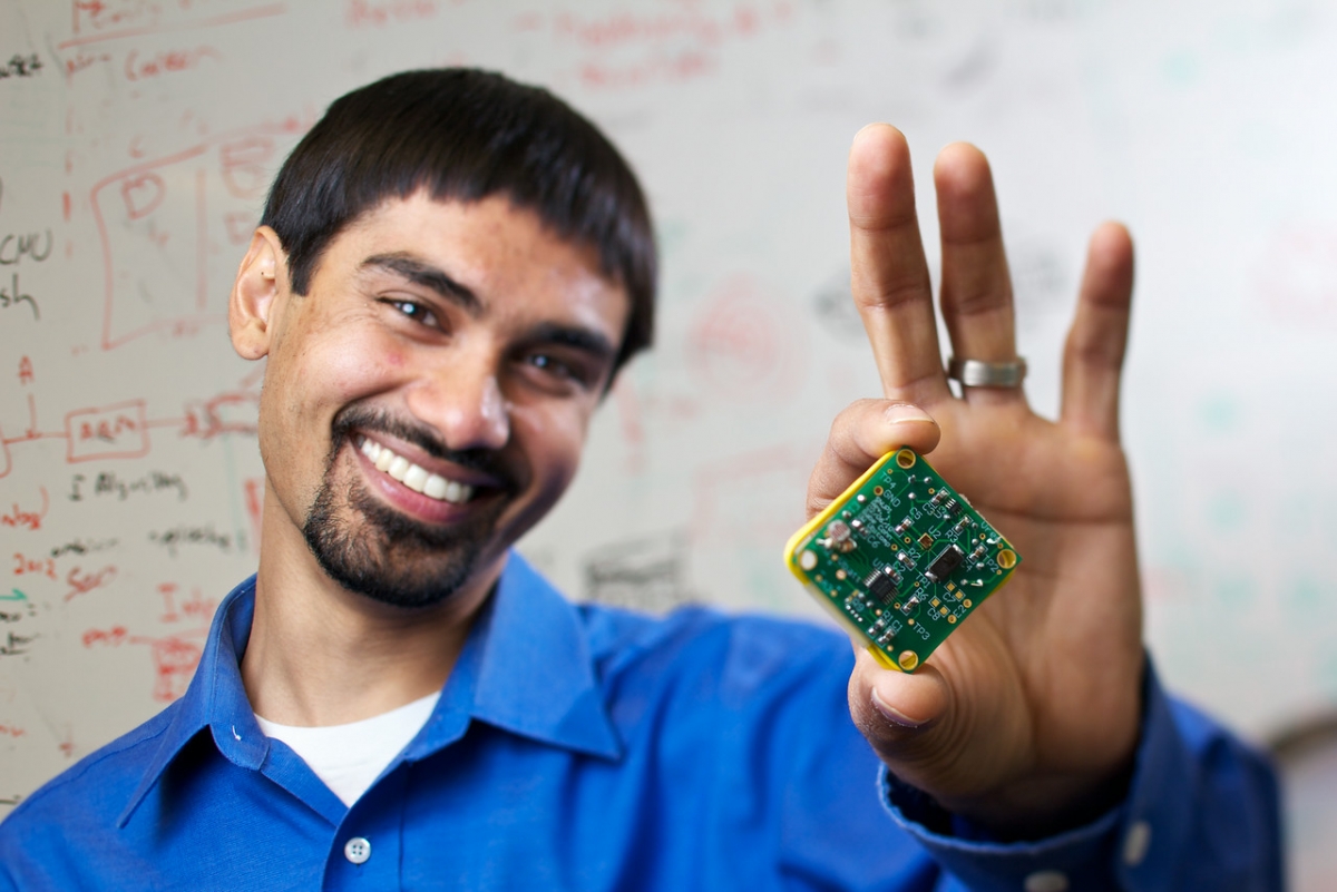 Person holding a small circuit board.